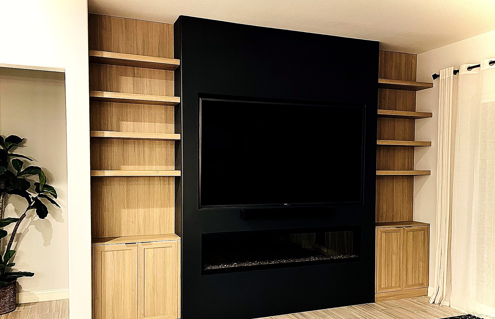 Black TV & fireplace wall